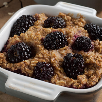 oatmeal topped with blackberries in a baking dish