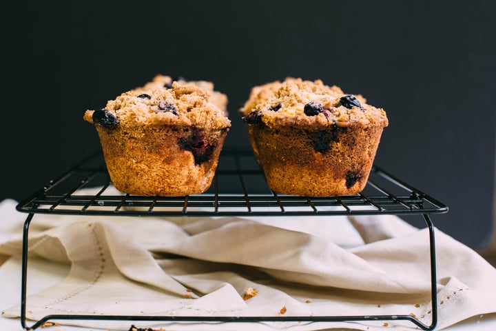 blueberry coffee cake muffins on a cooling rack