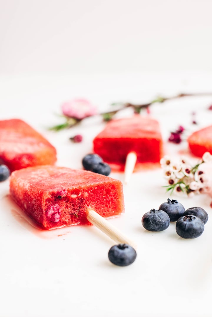 champagne strawberry popsicles with blueberries on the side