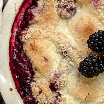 berry cobbler topped with blackberries