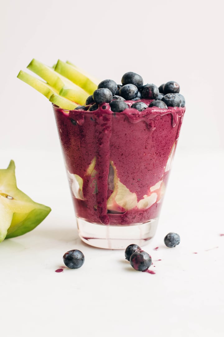 blueberry smoothie topped with blueberries and starfruit