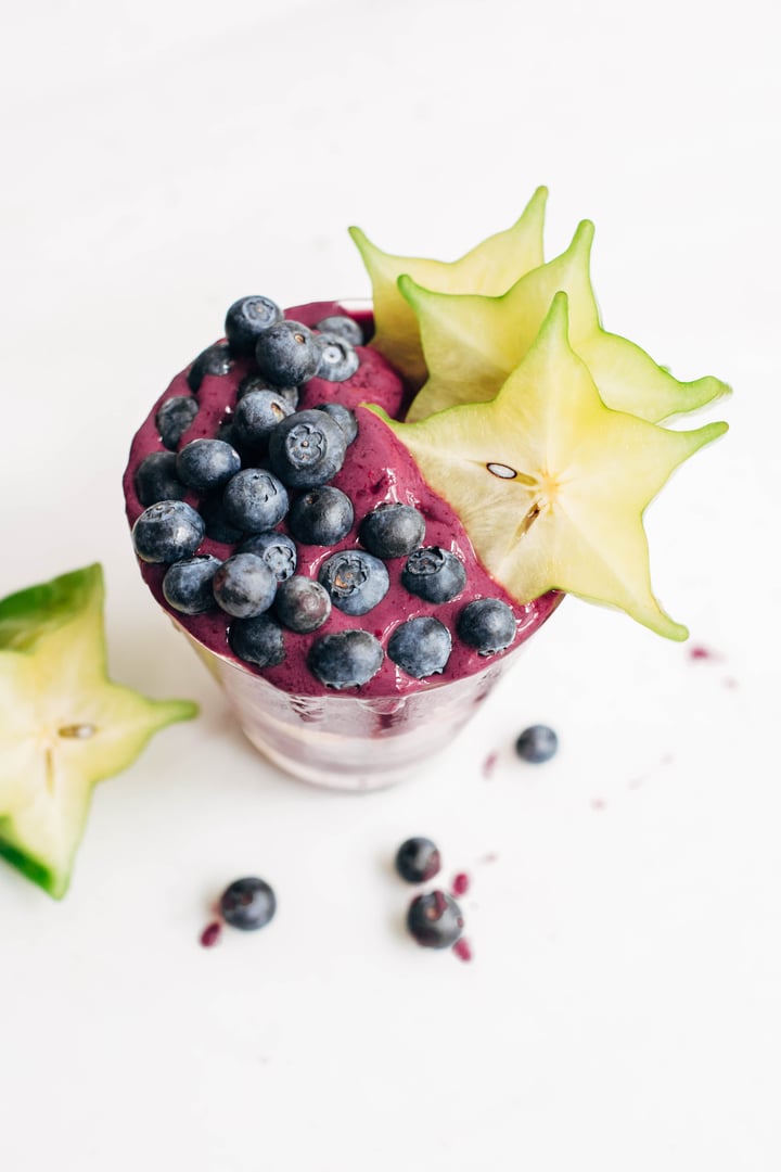 blueberry smoothie topped with blueberries and starfruit