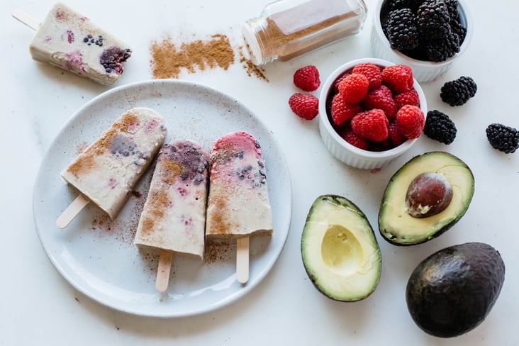 Berry horchata popsicles with a side of raspberries, blackberries, avocados, and cinnamon