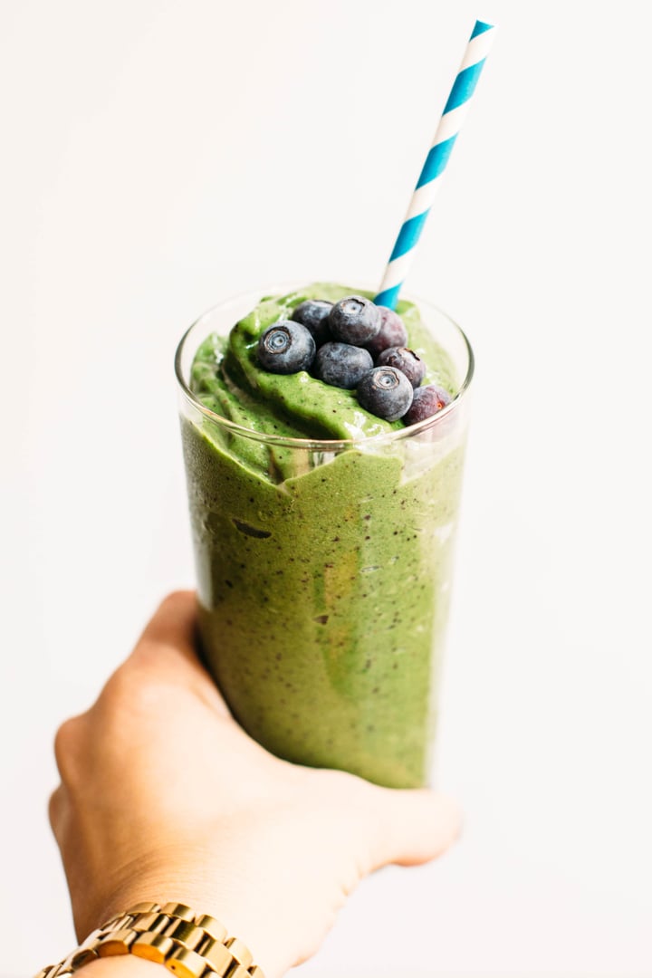 green smoothie topped with blueberries