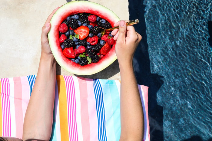 a hollow watermelon made into a bowl filled with berries