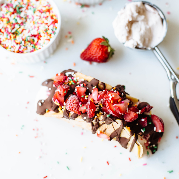 choco taco topped with strawberries and sprinkles