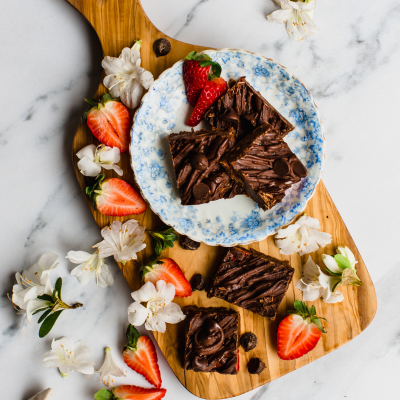 chocolate chip strawberry brownies on a plate and on a wooden board