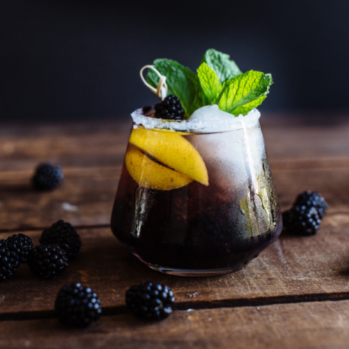 apple bourbon blackberry sour garnished with mint leaves