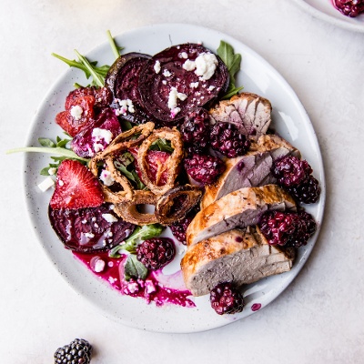 tenderloin topped with blackberries and a strawberry beet salad