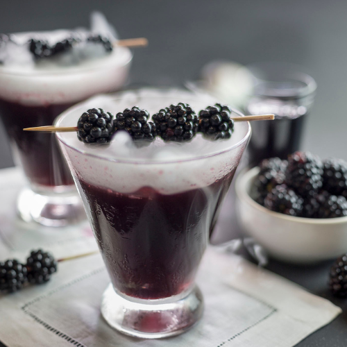 berry cocktail topped with blackberries