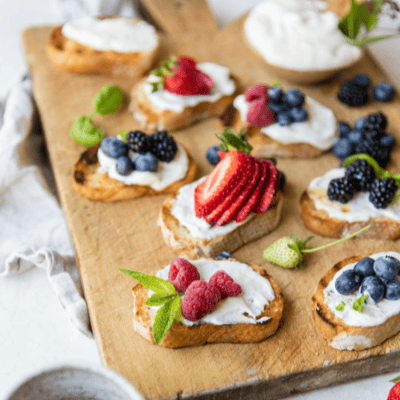 bruschetta bites with honey yogurt spread and topped with berries