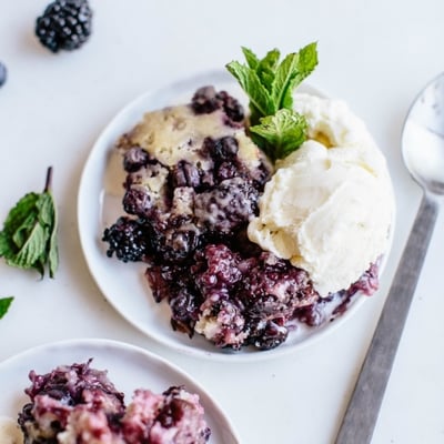 blueberry and blackberry cobbler topped with vanilla ice cream
