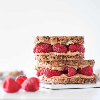 two peanut butter and raspberry sandwiches