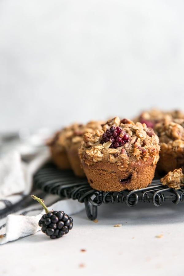 closeup of a blackberry muffin with pecan oat streusel