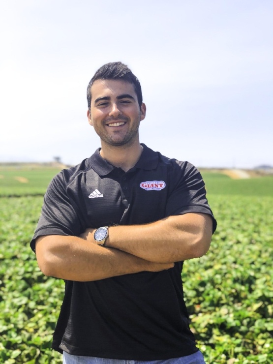 Logan Rusconi poses in front of a field