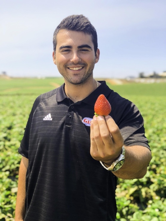 Logan Rusconi holding a strawberry