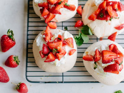 mini pavlovas with whipped cream and strawberries