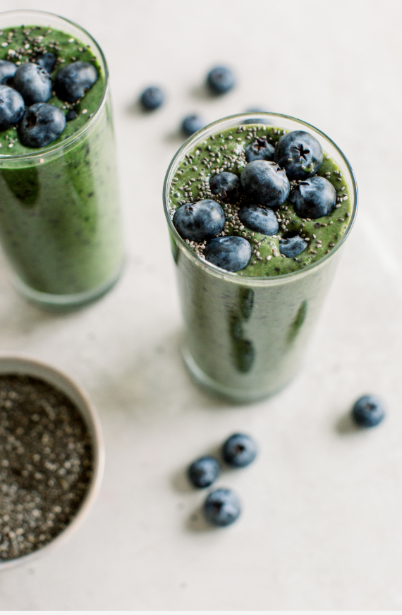 green smoothie topped with blueberries