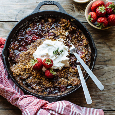 strawberry and oat skillet topped with whipped cream