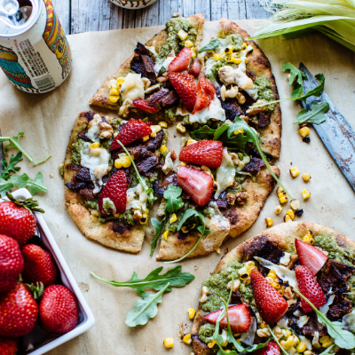 naan pizza with strawberries, corn, and bacon