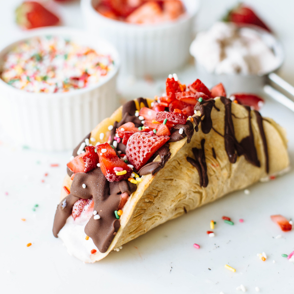choco taco topped with strawberries and sprinkles