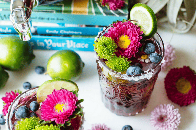 blueberry cocktail topped with lime and flowers