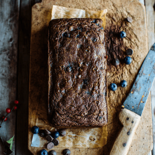 blueberry and dark chocolate chip pumpkin bread on a cutting board