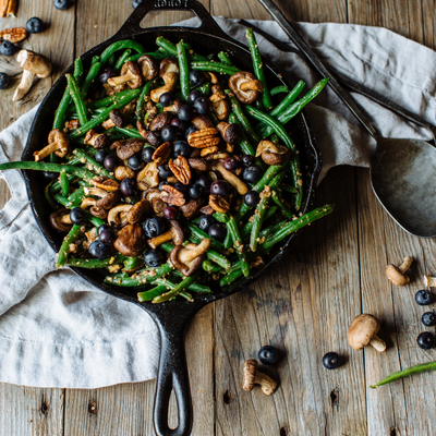 shitake and blueberry green beans salad in a cast iron pan 