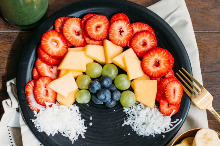 plate with berries, grapes, melon, and shredded coconut