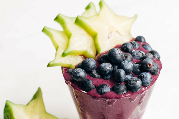 blueberry smoothie topped with blueberries and starfruit