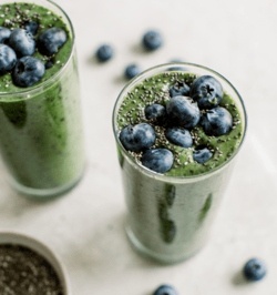 green smoothie with blueberries on top