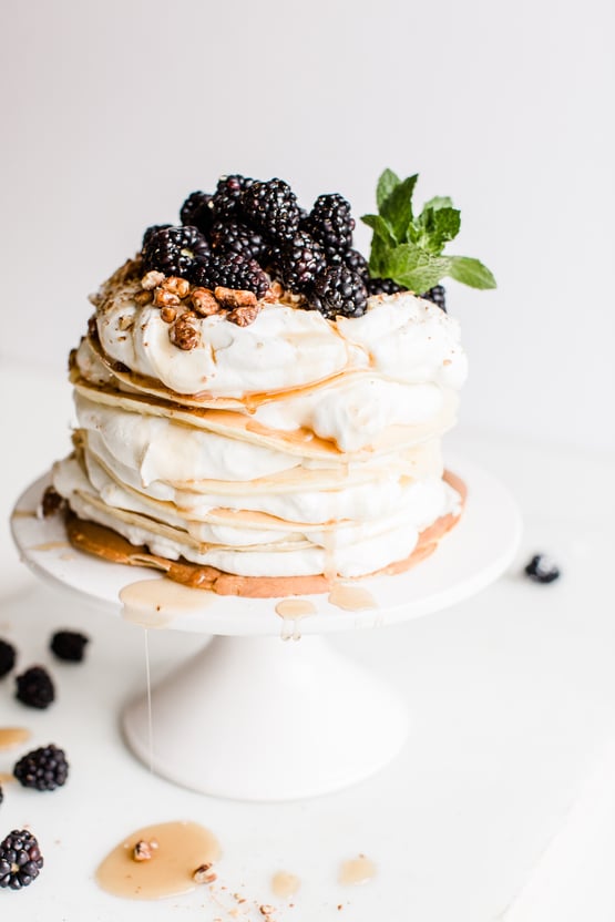 crepes topped with blackberries, whipped cream, and candied pecans