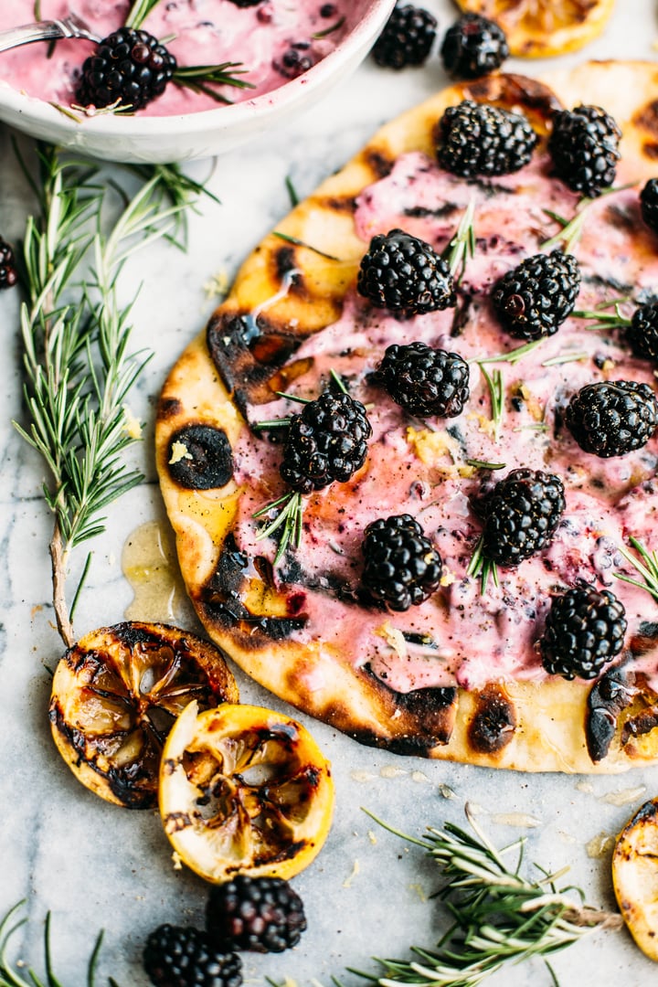 naan bread topped with goat cheese spread  and blackberries