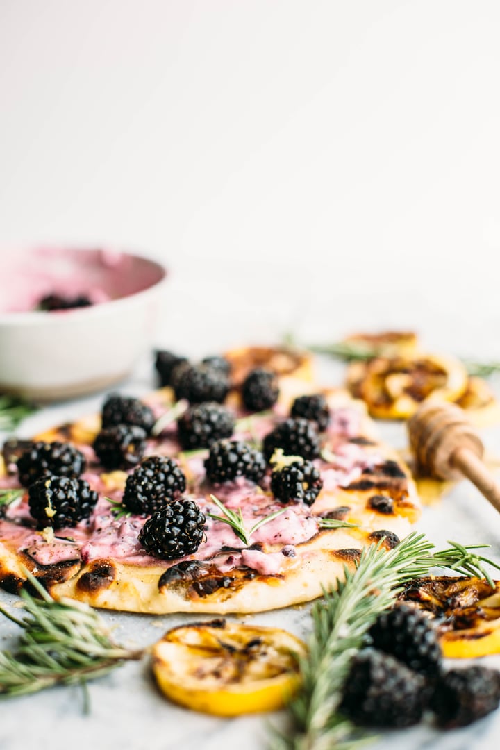 naan bread topped with goat cheese spread and blackberries