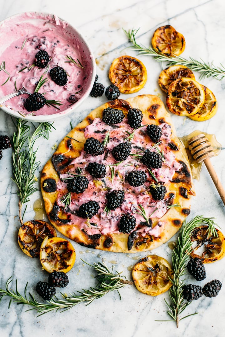 naan bread topped with goat cheese spread  and blackberries