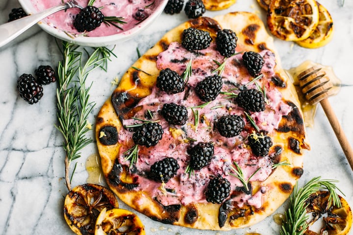 naan bread topped with goat cheese spread  and blackberries