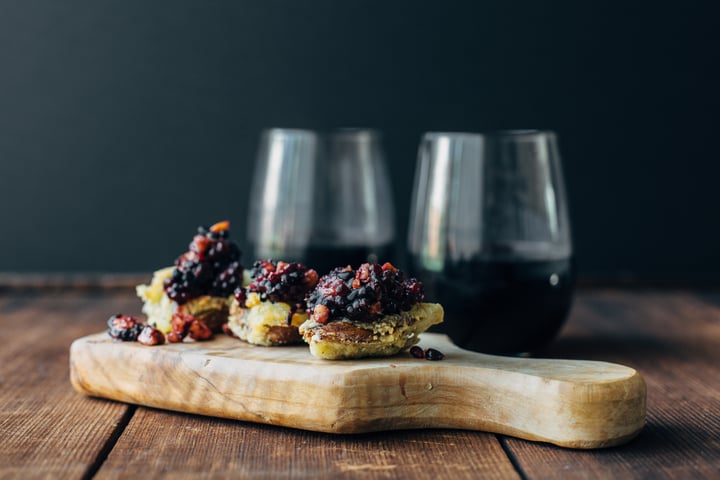 artichokes with blackberry pesto on a wooden board