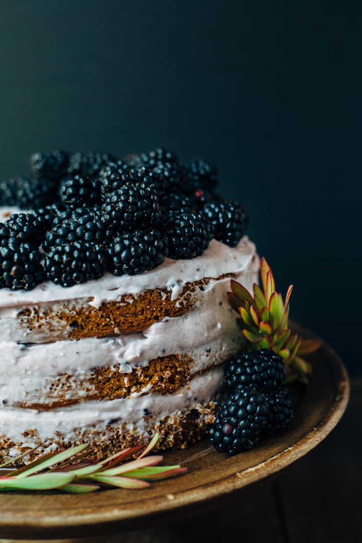 blackberry pumpkin spice cake topped with blackberries and frosting