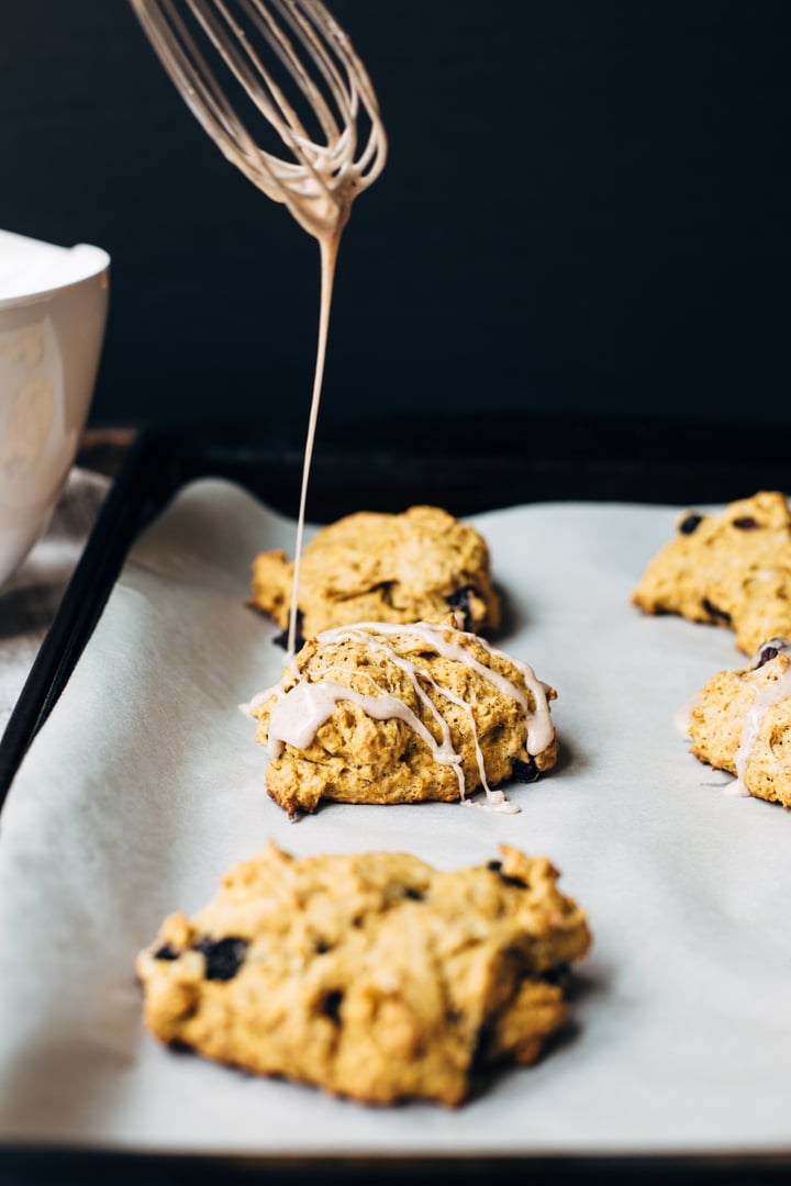 blueberry pumpkin scone drizzled with a blueberry glaze