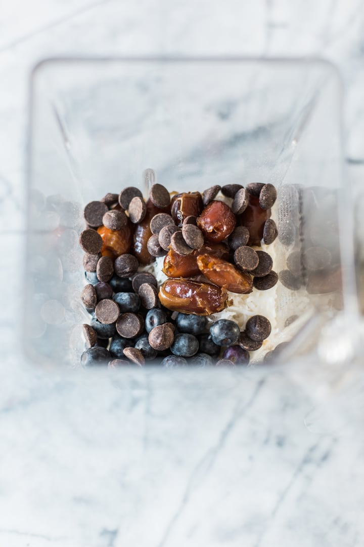 blueberry, dates, chocolate chips, and shredded coconut in a blender