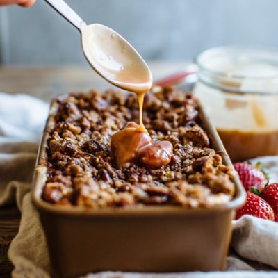 caramel coffee cake with a spoon drizzling caramel