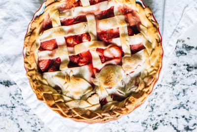 a strawberry pie with braided pie crust