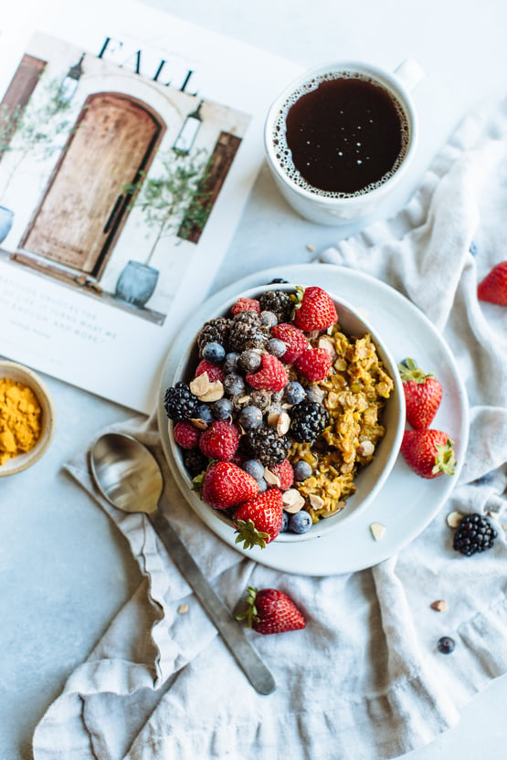 golden oatmeal topped with berries