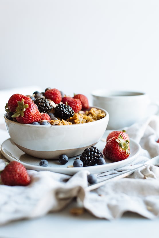 golden oatmeal topped with berries