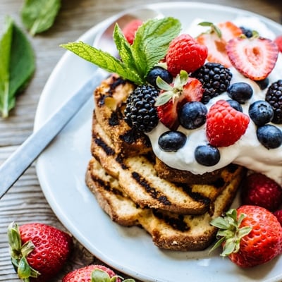 grilled pound cake topped with whipped cream and berries