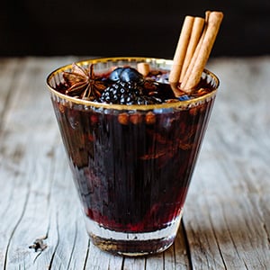 spiced holiday sangria topped with a cinnamon stick
