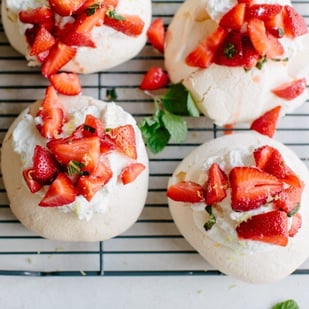 mini pavlovas topped with strawberries