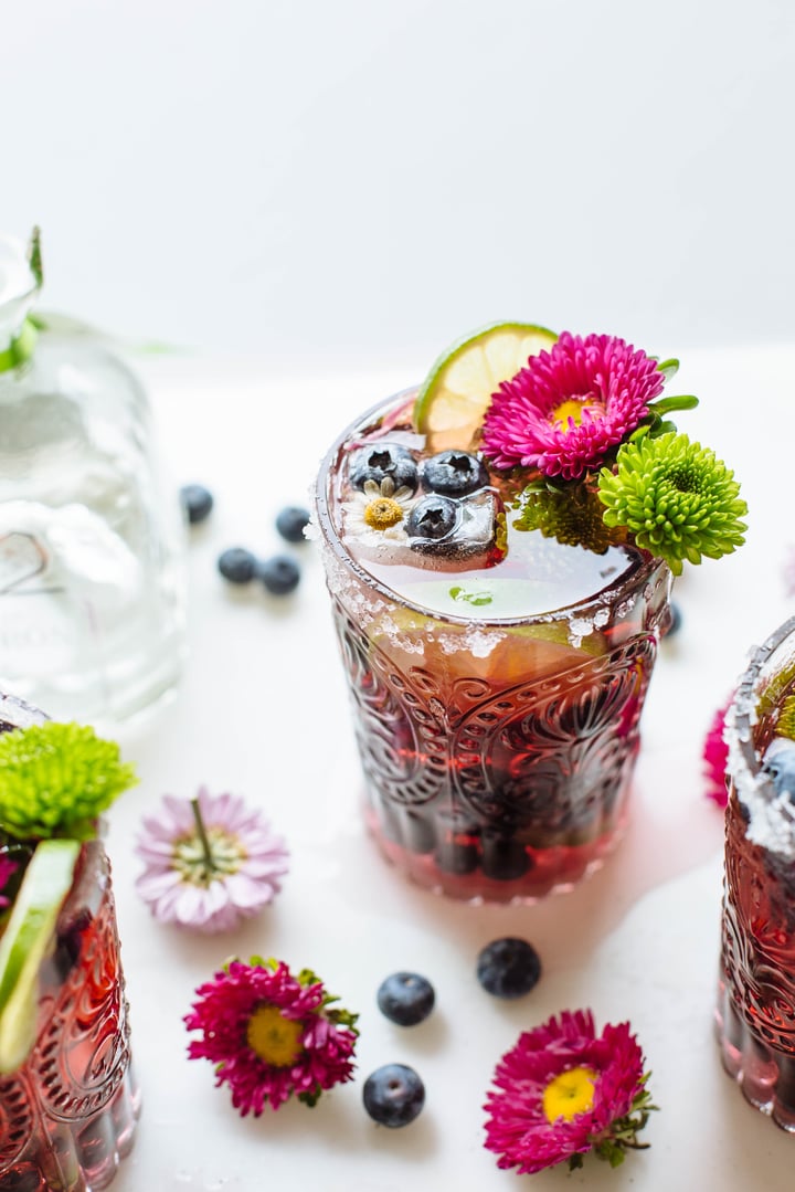 blueberry cocktail topped with lime and flowers