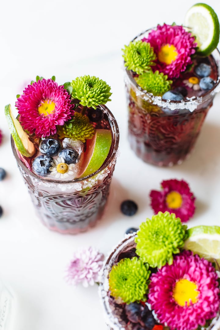 blueberry cocktail topped with lime and flowers