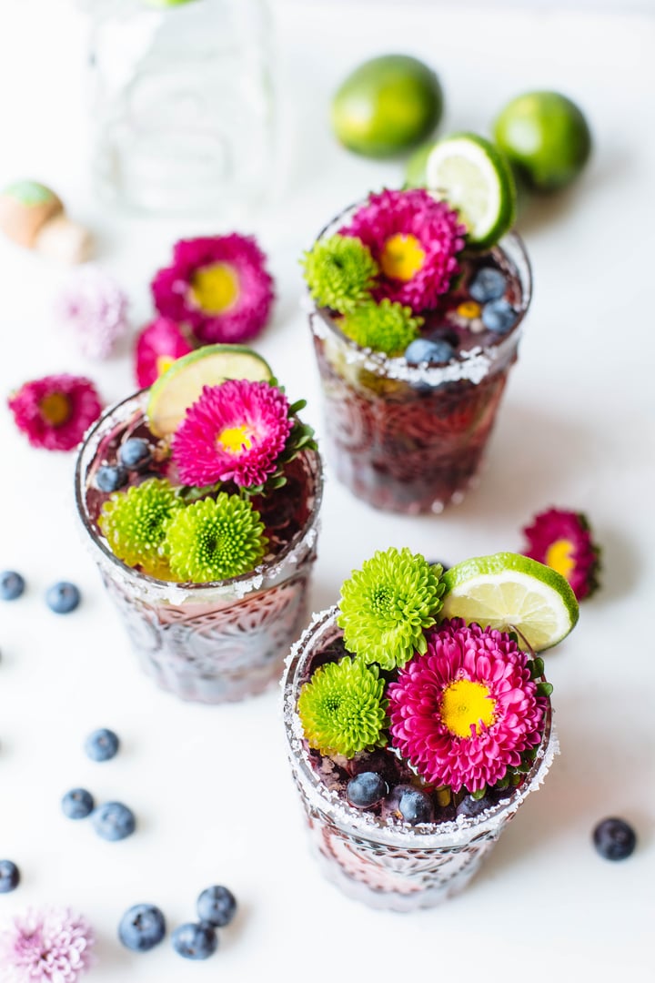 blueberry cocktail topped with lime and flowers